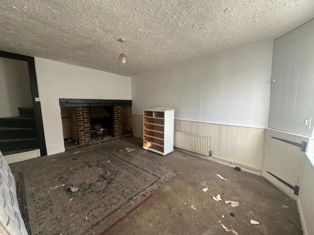 Lot: 22 - TWO-BEDROOM HOUSE FOR REFURBISHMENT - Living room with fireplace